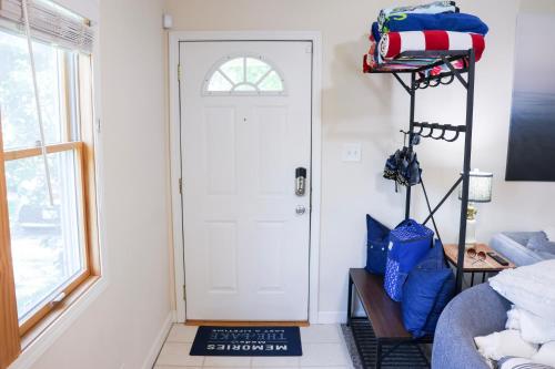 a room with a door and a shelf with baseball gear at Walk To Beach And Downtown Lake Geneva! in Lake Geneva