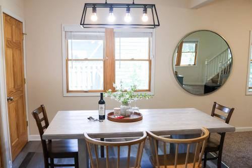 a dining room with a table and a mirror at Walk To Beach And Downtown Lake Geneva! in Lake Geneva