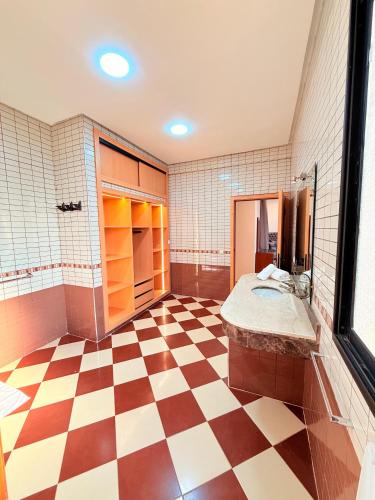 a bathroom with a checkered floor and a sink at Villa Patel in Marrakech