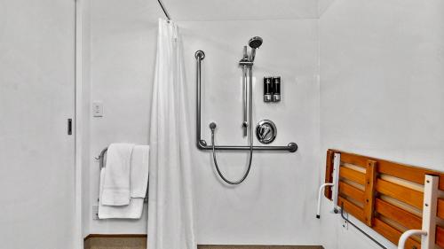 a shower with a shower curtain in a bathroom at Bella Vista Motel Rotorua in Rotorua