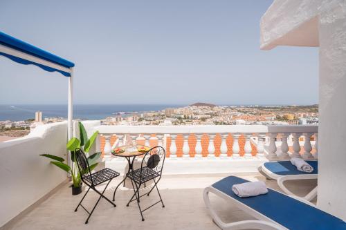 a balcony with a table and chairs and a view at Sunset view, Los Cristianos - Port Royale in Los Cristianos