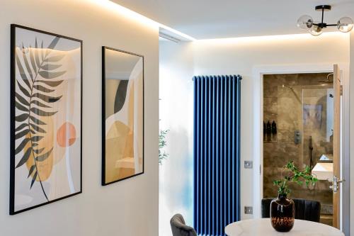 a room with a table and some pictures on the wall at Modern apartment in town centre in Oban