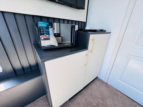 a microwave on a counter next to a door at Pacific Hotel in Clacton-on-Sea