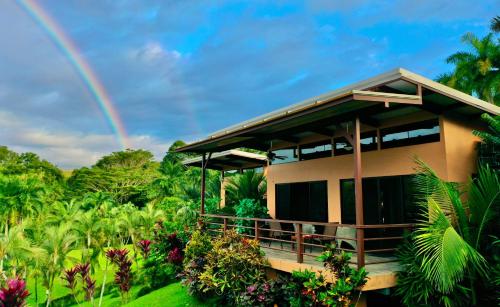 a house with a rainbow in the background at 3 bedrooms Ocean view Villa Keanu in Pavones
