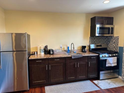 a kitchen with a stainless steel refrigerator and a stove at JD Apartment and House in Seaside Heights