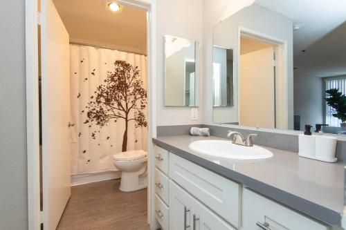 a bathroom with a sink and a toilet at Stylish 2BR Apt with Rooftop Pool & Hollywood Views in Los Angeles