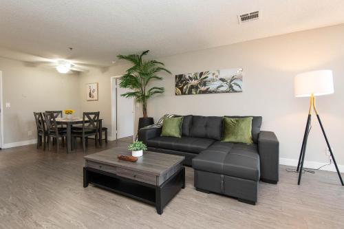 a living room with a couch and a table at Stylish 2BR Apt with Rooftop Pool & Hollywood Views in Los Angeles
