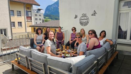 a group of people posing for a picture on a patio at Premium Apartments - central & historical in Meiringen