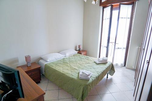 a bedroom with a bed and a television in it at Terrazza di Alfieri - Alloggio con terrazza privata nel centro di Asti in Asti