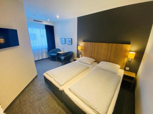 Ένα ή περισσότερα κρεβάτια σε δωμάτιο στο Egon Hotel Hamburg City