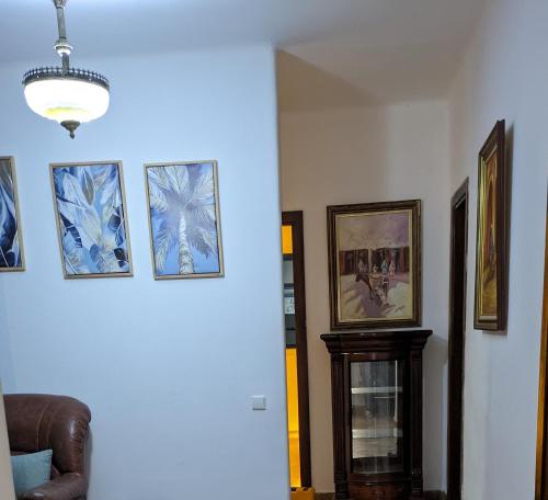 a living room with pictures on the wall and a couch at Marina Smir Compounds Pool & Beach in Marina Smir