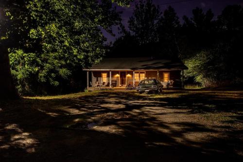 a house with a car parked in front of it at Stranger Things - Byers Home - 15 Min to ATL in Fayetteville