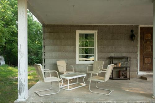 a group of chairs and a table on a porch at Stranger Things - Byers Home - 15 Min to ATL in Fayetteville
