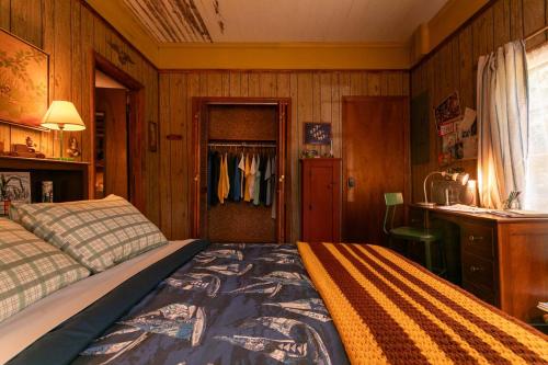 a bedroom with a bed and a desk and a closet at Stranger Things - Byers Home - 15 Min to ATL in Fayetteville