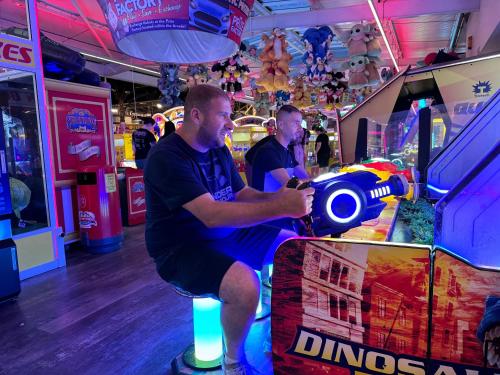 two men playing a video game in a arcade at Pacific Hotel in Clacton-on-Sea