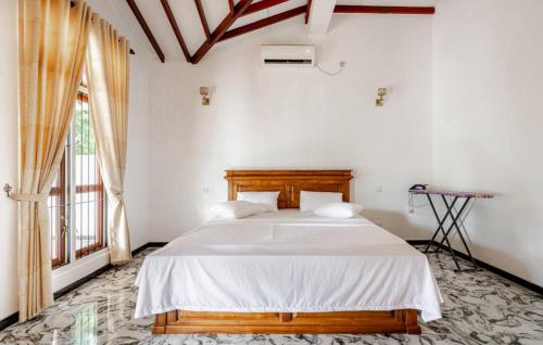 Ένα ή περισσότερα κρεβάτια σε δωμάτιο στο Palmwood Retreat - Entire 3 Bed room House with AC and Parking