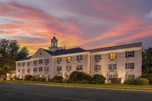 a large white building with a clock tower on top at Best Western PLUS Morristown Inn-Florham Park in Morristown