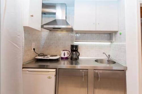 a kitchen with a sink and a counter top at Apartments Barbie in Rethymno Town