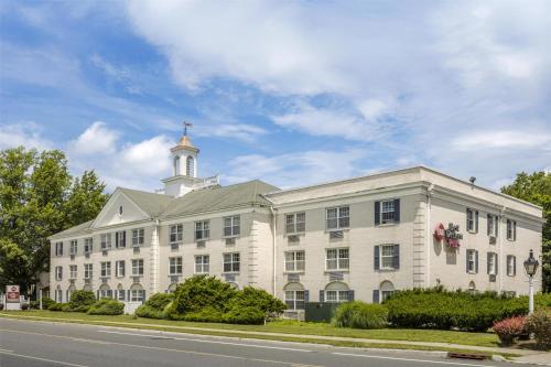a large white building with a tower on top of it at Best Western PLUS Morristown Inn-Florham Park in Morristown
