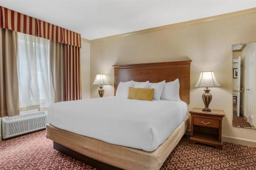 a hotel room with a large bed and a window at Best Western PLUS Morristown Inn-Florham Park in Morristown