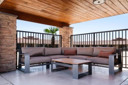 a couch and a coffee table on a patio at Aiden by Best Western St George in St. George