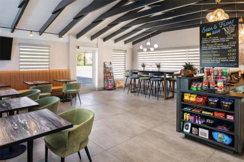 a restaurant with tables and chairs and a menu at Aiden by Best Western St George in St. George