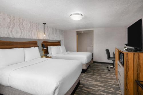 a hotel room with two beds and a flat screen tv at Aiden by Best Western St George in St. George