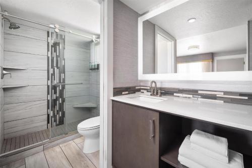 a bathroom with a sink and a toilet and a mirror at Aiden by Best Western St George in St. George