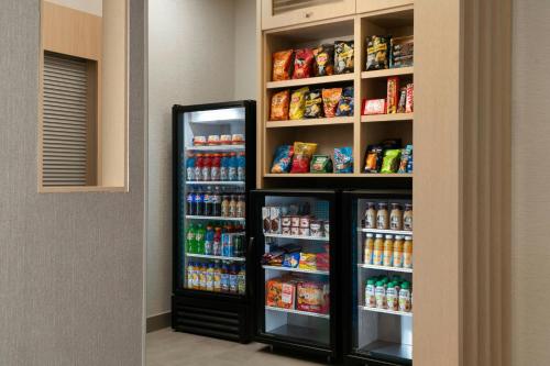 a refrigerator in a room with food and drinks at TownePlace Suites by Marriott Allentown West in Allentown