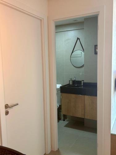 a bathroom with a sink and a mirror at Apto recém-inaugurado, com vista mar, a alguns passos da praia e do melhor shopping de Maceió! in Maceió