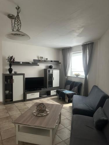 a living room with a couch and a table at Ferienwohnung am Nurburgring in Welcherath