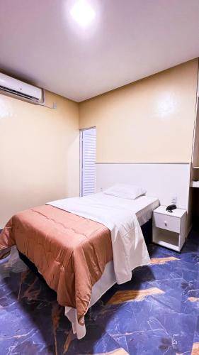 a bedroom with a large bed in a room at Hotel Amazonida in Manaus