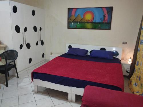 a bedroom with a large bed with a red blanket at 80-1 CRISS RESORT-CITY CENTER-NAAMA BAy in Sharm El Sheikh