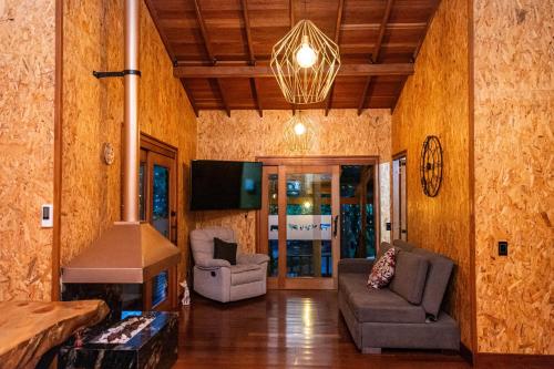 a living room with a couch and a stove at Cabañas El Edén in Chía
