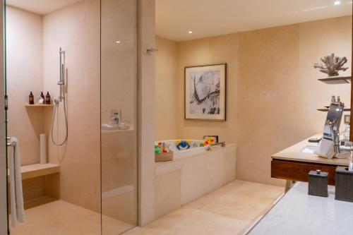 a bathroom with a shower and a sink at Grand Velas Los Cabos Luxury All Inclusive in Cabo San Lucas