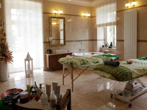 a bathroom with two beds and a bath tub at Hotel Zámek Berchtold in Kunice - Vidovice