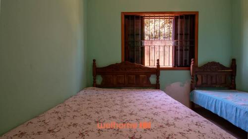 Ένα ή περισσότερα κρεβάτια σε δωμάτιο στο Casa de campo em Cotia com piscina e lazer