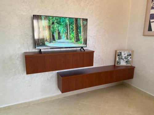 a flat screen tv hanging on a wall at Ciel&Azur in Sidi Ifni