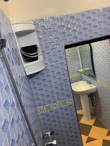 a bathroom with a sink and a mirror at Adoir N'salh in Tiznit