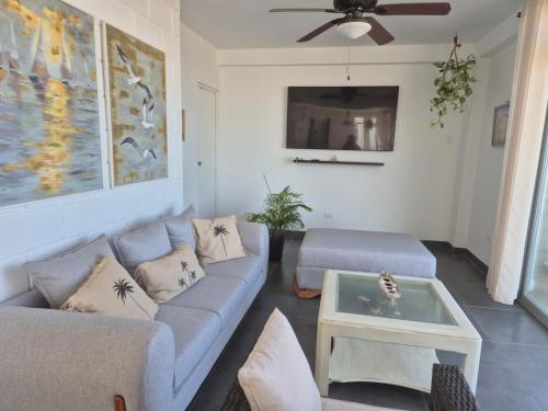 a living room with a couch and a table at Casa Palmar Oceanfront paradise in Zorritos in Zorritos