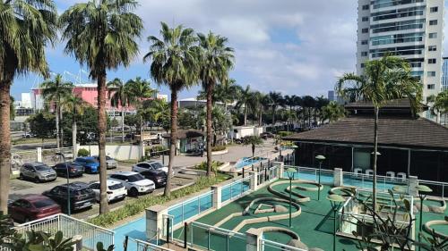 a water park with a slide in a parking lot at Bora Bora Barra Apartments in Rio de Janeiro
