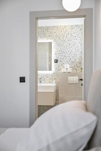 a bathroom with a tub and a sink and a mirror at Villa Nino in Sukošan