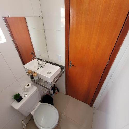 a small bathroom with a toilet and a sink at Pousada Loft Marabá in Marabá