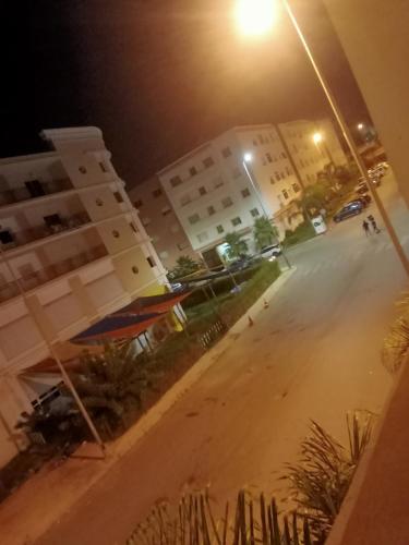 an empty street in front of a building at night at Casa sabir in Temara
