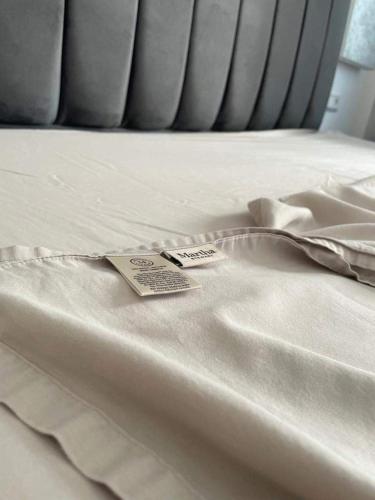 a white bed with a price tag on it at Beachfront First floor mekad in Oued Laou