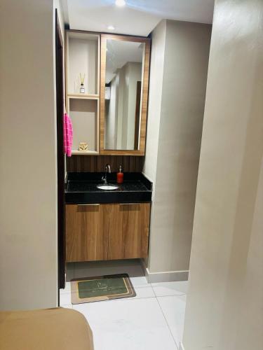 a bathroom with a sink and a mirror at Prive Beira Mar Tamandare in Tamandaré