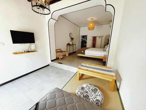 a living room with a bed and a mirror at 隐谷私院The Great Wall Valley in Gubeikou