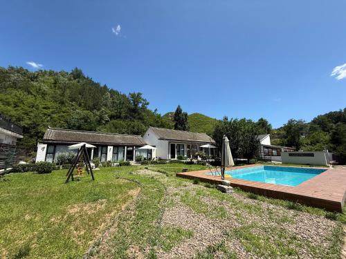 a house with a swimming pool in a yard at 隐谷私院The Great Wall Valley in Gubeikou
