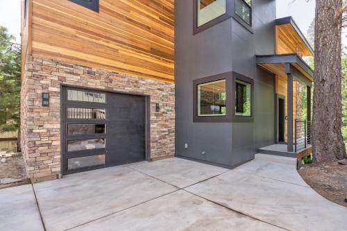 a house with a garage and a brick wall at Mariposa Grove Creekside Retreat in Fish Camp