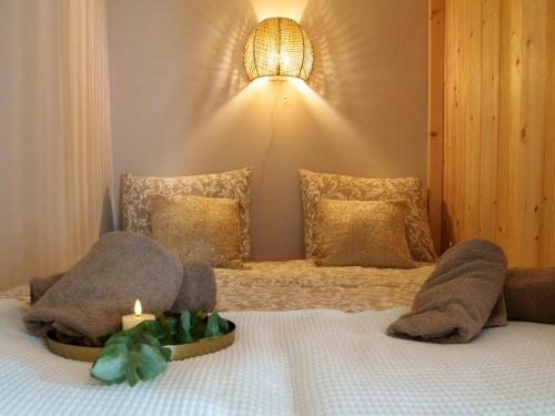 a bedroom with a bed with a candle on it at De Vale in Hattemerbroek